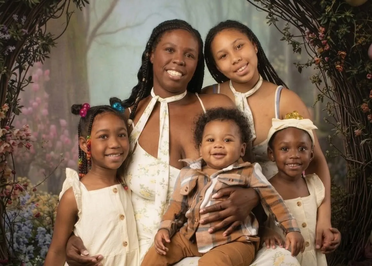 Sisters in cream outfits holding a baby and toddler on the Enchanted Garden set