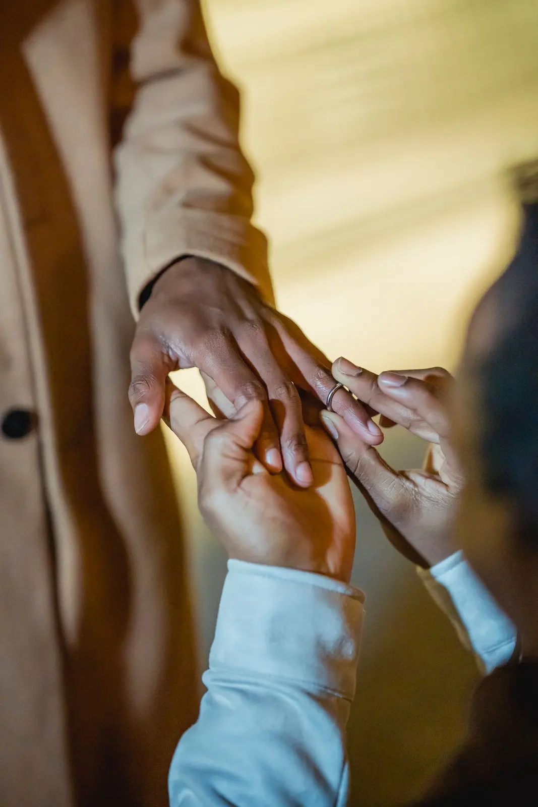 A ring being slipped onto a hand during a proposal